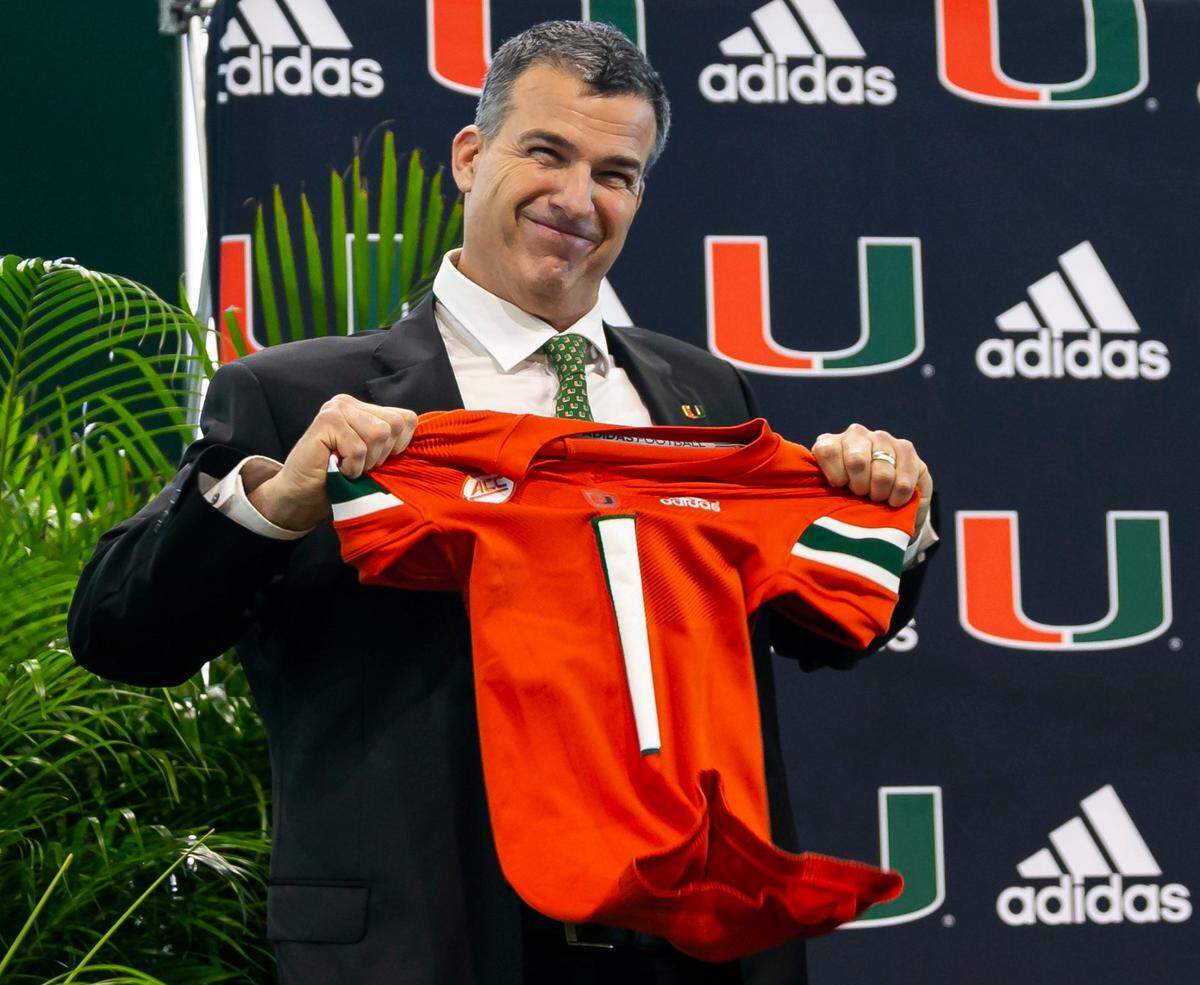 Mario Cristobal, the newly hired head football coach of the Miami Hurricanes, reacts after being given a jersey during a press conference at the Carol Soffer Indoor Practice Facility inside the University of Miami in Coral Gables, Florida, on Tuesday, Dec. 7, 2021.