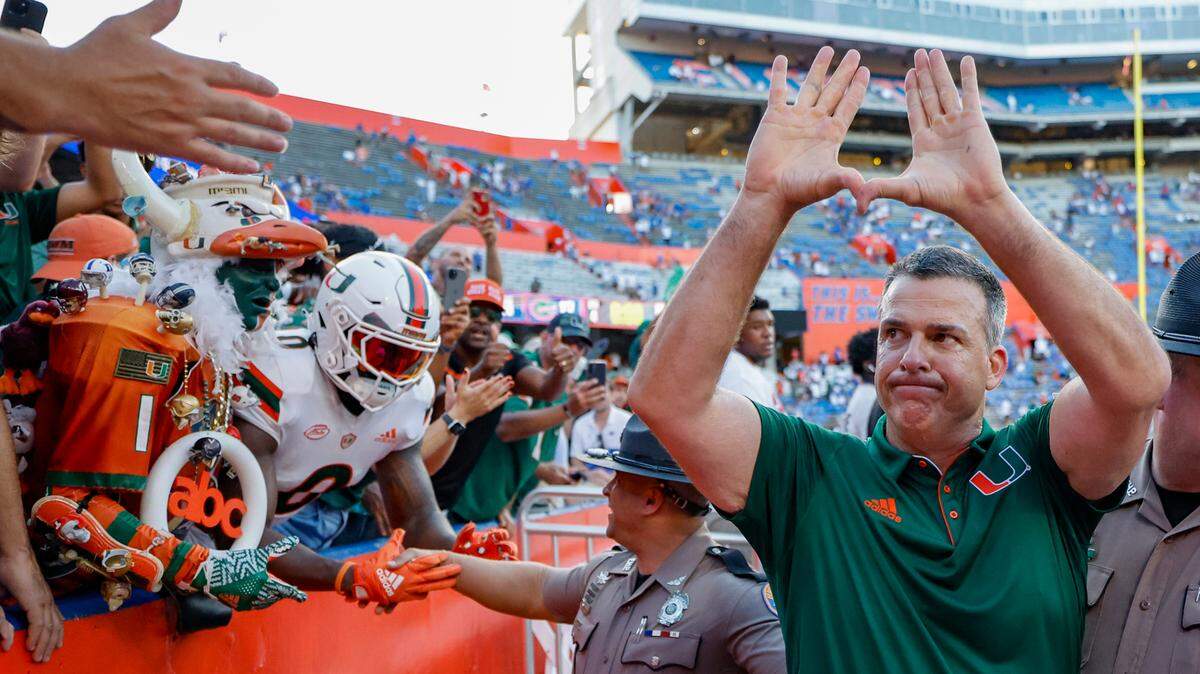 Miami Hurricanes head coach Mario Cristobal flashes the U as the fans celebrate the Canes defeating the Florida Gators in an NCAA college football game at Ben Hill Griffin Stadium in Gainesville, Florida, on Saturday, August 31, 2024.