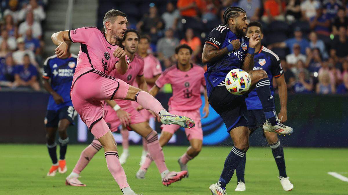 Jul 6, 2024; Cincinnati, Ohio, USA; Inter Miami CF defender Sergii Kryvtsov (27) kicks the ball against FC Cincinnati defender DeAndre Yedlin (91) in the second half at TQL Stadium. Mandatory Credit: Trevor Ruszkowski-USA TODAY Sports