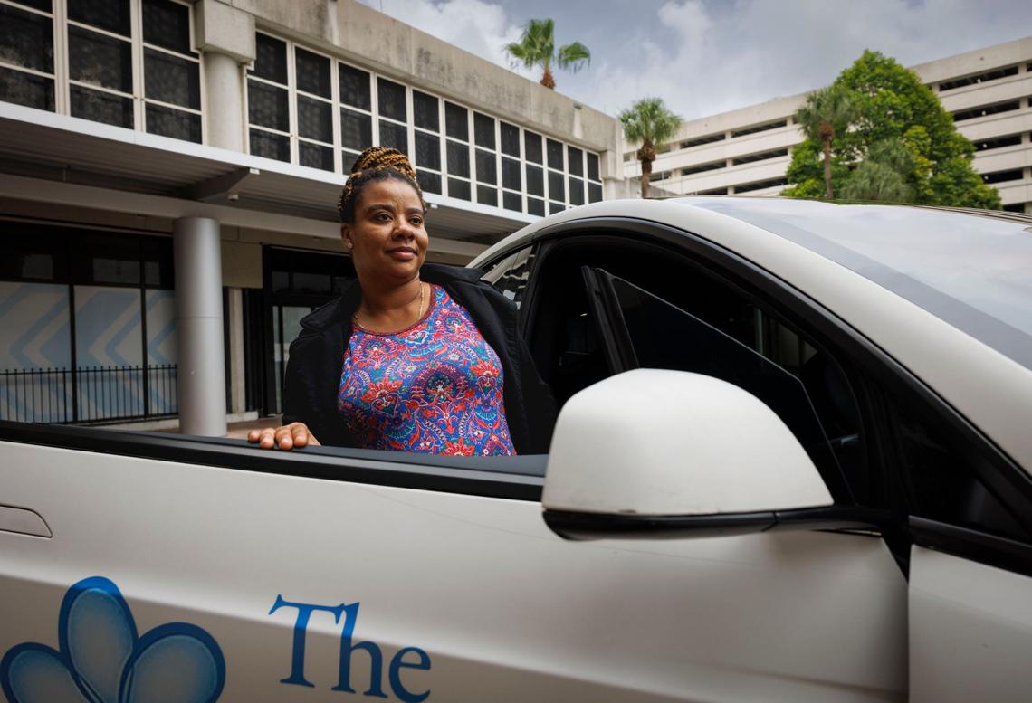Marie Odvil uses a free car service for low-income pregnant mothers provided by Green Cars for Kids in partnership with Freebee and Jackson Health on Wednesday, Aug. 28, 2024, outside of Holtz Children’s Hospital on Jackson’s campus in Miami.
