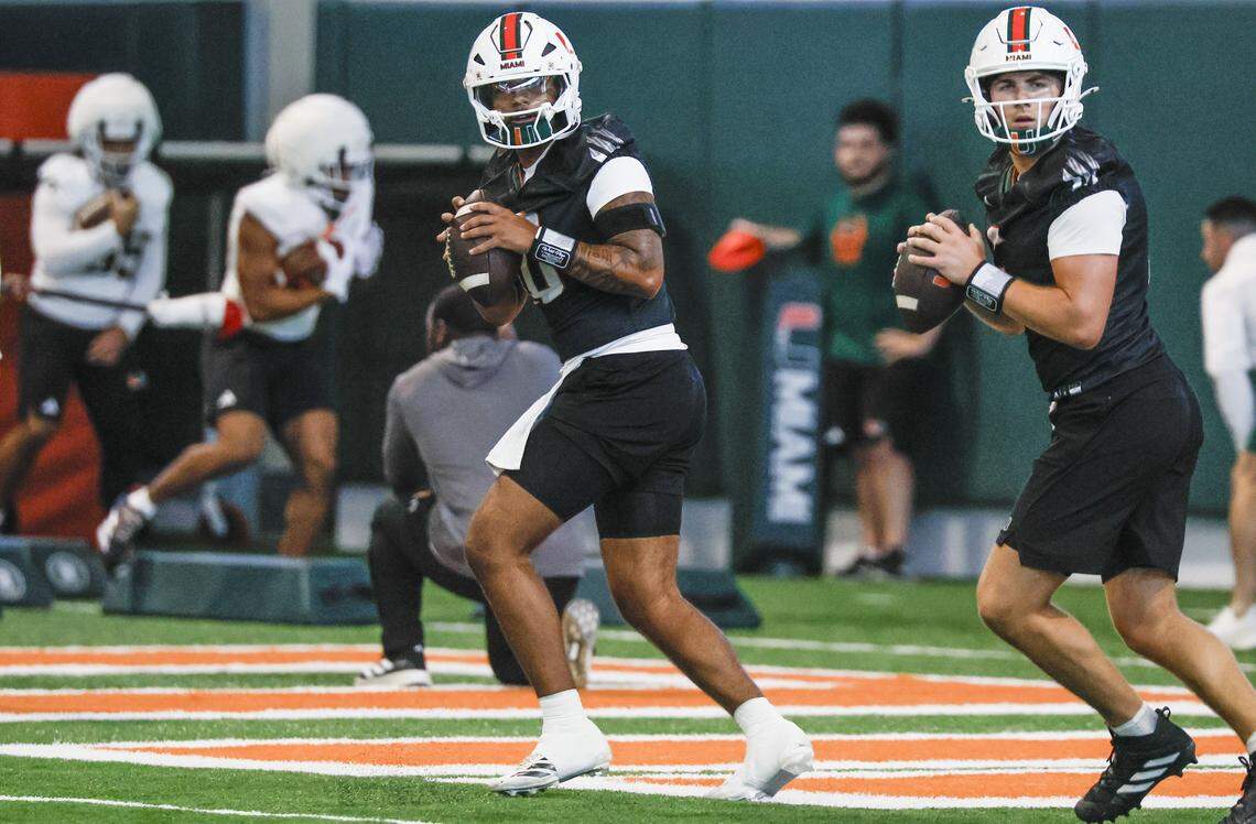 Miami Hurricanes quarterback Darian Mensah (10) and quarterback Luke Nickel (5) set up to pass during drills at the Carol Soffer Indoor Practice Facility on the University of Miami campus in Coral Gables, Florida, on Tuesday morning, March 24, 2026.