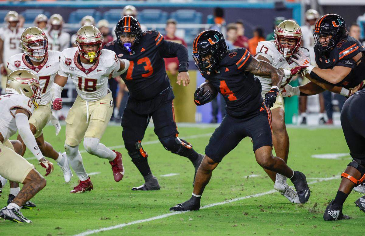 Miami Hurricanes running back Mark Fletcher Jr. (4) on a carry against the Florida State Seminoles in the first half during an NCAA football game at Hard Rock Stadium in Miami Garden, Florida on Saturday, October 26, 2024. 