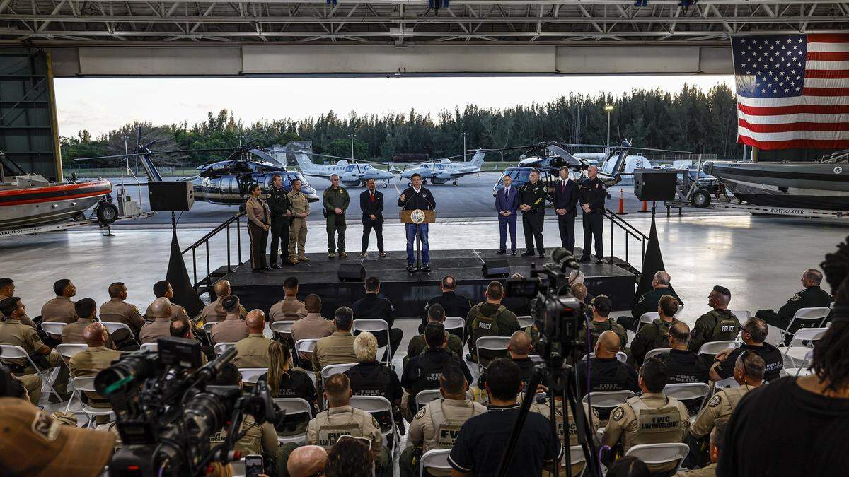 Florida Gov. Ron DeSantis holds a media conference at the Homestead Air Reserve Base alongside Department of Homeland Security Senior Counselor Keith Pearson in Homestead, Florida, on Wednesday, Feb. 26, 2025.
