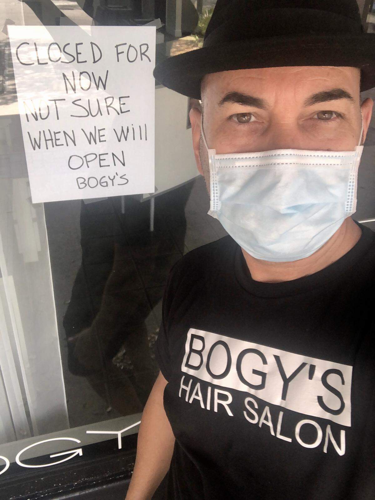 Hairstylist Rolando Torres in front of his Bogy’s Hair Salon in Miami Lakes, closed amid the coronavirus crisis.