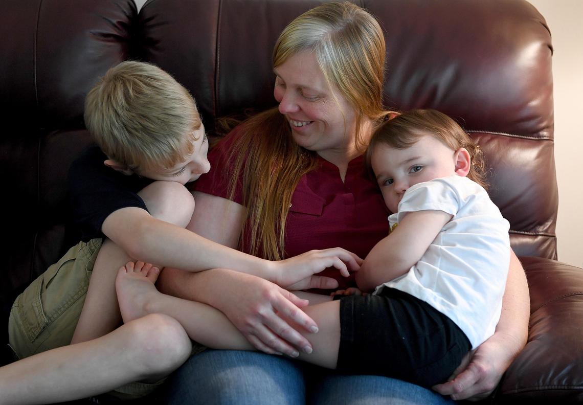 Kimberly Babbitt sits on a couch in her grandmother’s home in Lutz with her two youngest children, Brice and Bailey Hanson, 8 and 2. Babbitt is the girlfriend of Kevin Hanson, who took photos of the cracks in the Florida International University pedestrian bridge and passed along warnings before the tragic collapse.