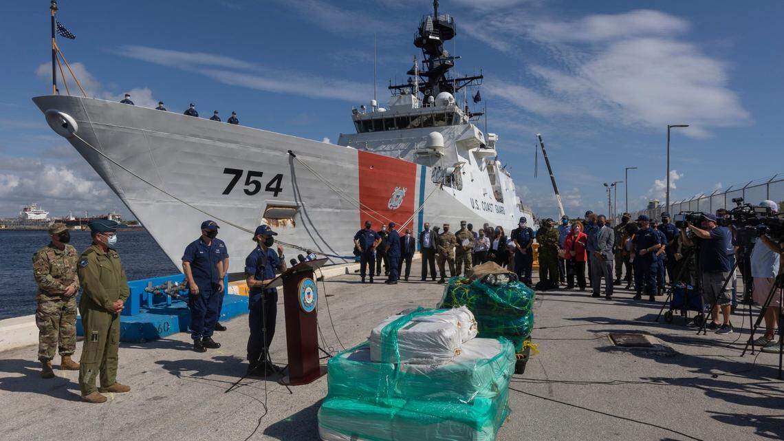On Thursday, Aug. 5, 2021, officials from the U.S. Coast Guard and the Canadian military speak during a press conference at Port Everglades alongside pallets of seized drugs, and with the USCGC James in the background. The partner organizations offloaded about 59,700 pounds of cocaine and 1,430 pounds of marijuana from multiple Eastern Pacific and Caribbean Sea interdictions.