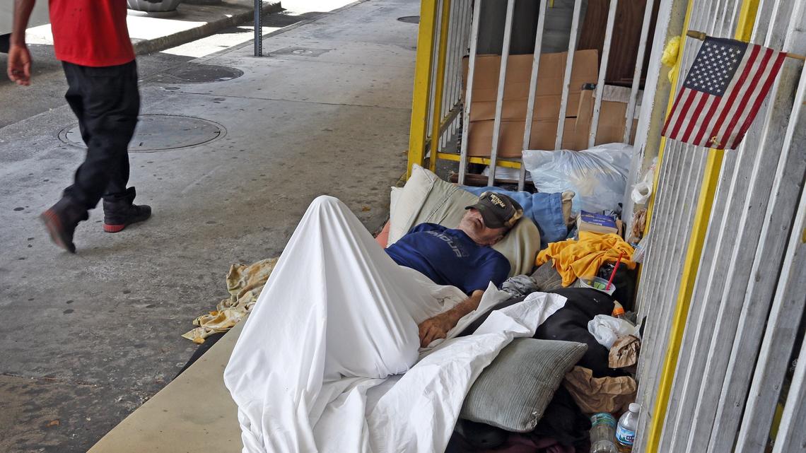 Joe Wright, a homeless Vietnam War veteran, sleeps on the street in downtown Miami, where passersby find feces and urine in the street and on sidewalks.