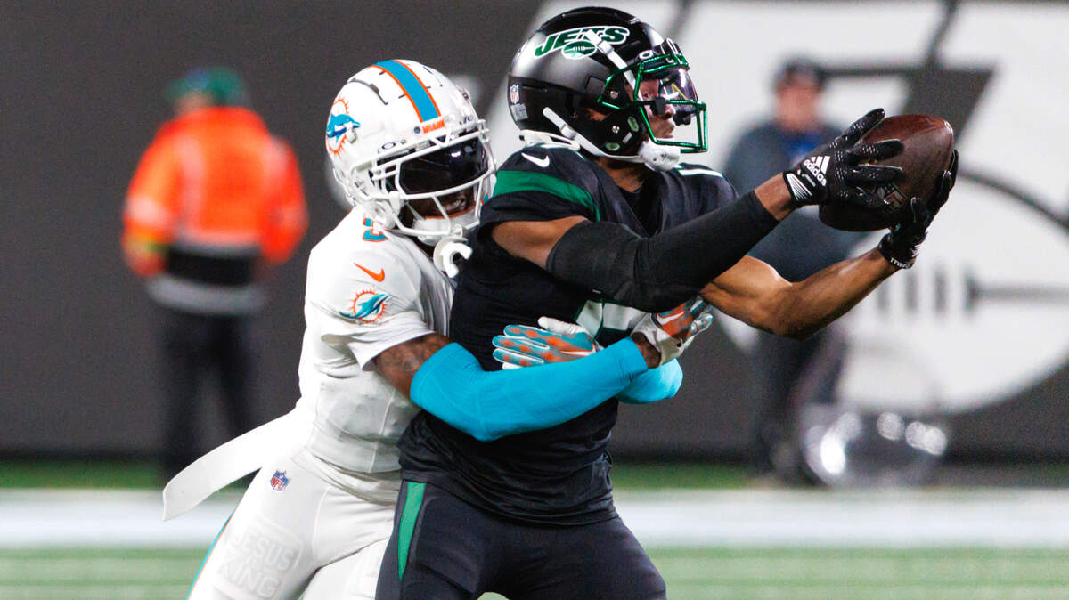 Miami Dolphins cornerback Jalen Ramsey (5) tackles New York Jets wide receiver Garrett Wilson (17) during fourth quarter of an NFL football game at MetLife Stadium on Friday, Nov. 24, 2023 in East Rutherford, New Jersey.
