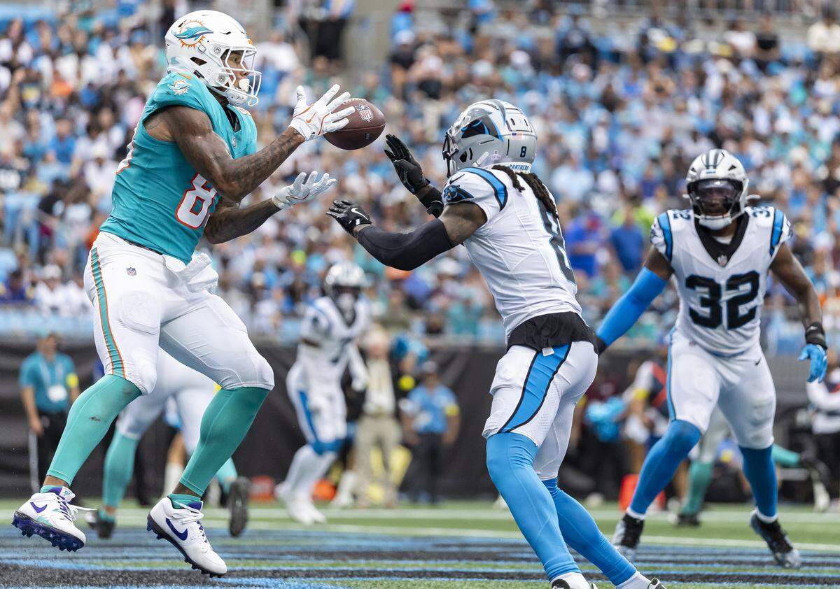 Miami Dolphins tight end Darren Waller (83) catches a touchdown pass as Carolina Panthers cornerback Jaycee Horn (8) defends in the first half of their NFL game at the Bank of America Stadium on Sunday, Oct. 5, 2025, in Charlotte, N.C.
