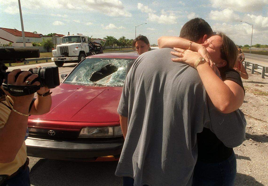 Yanier Torres getting a hug from his wife Angela Oria after she came to the scene of his accident. It was a case of road debris, a sheet of steel went through the front windshield and in to the back window.This happened on the turpike just north of Snapper Creek Plaza