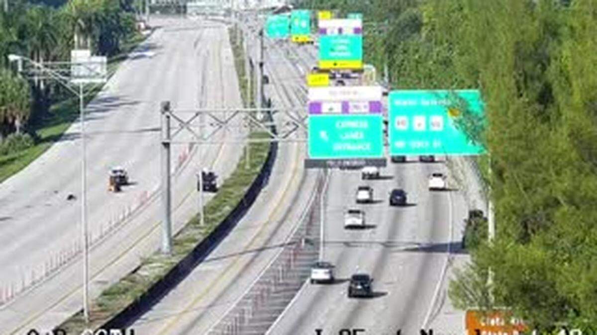 The closed northbound Interstate 95 lanes, on the left, after a massive crash Sunday morning.
