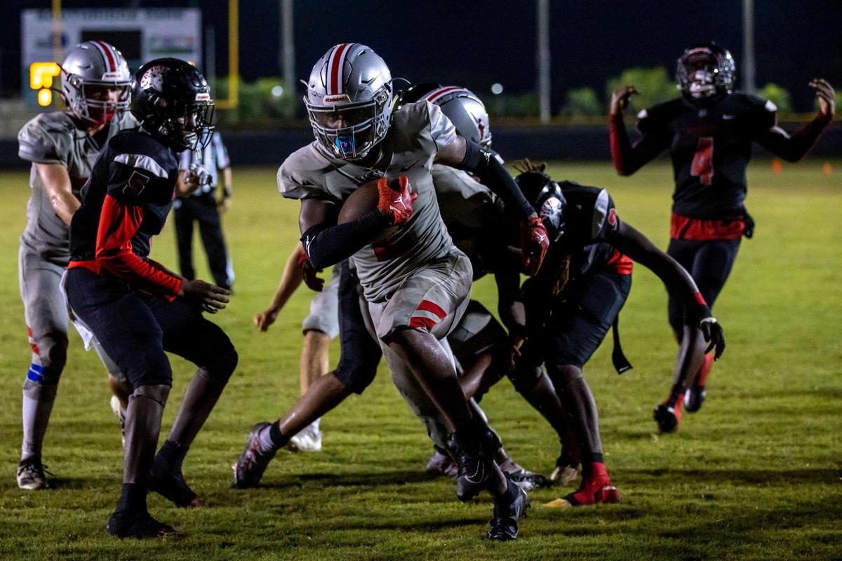 Doral Academy running back Mark Wilder (2) scores a touchdown during the over time of an high school football game against Miami Southridge at South Ridge Park in Miami, Florida, on Friday, September 24, 2022.