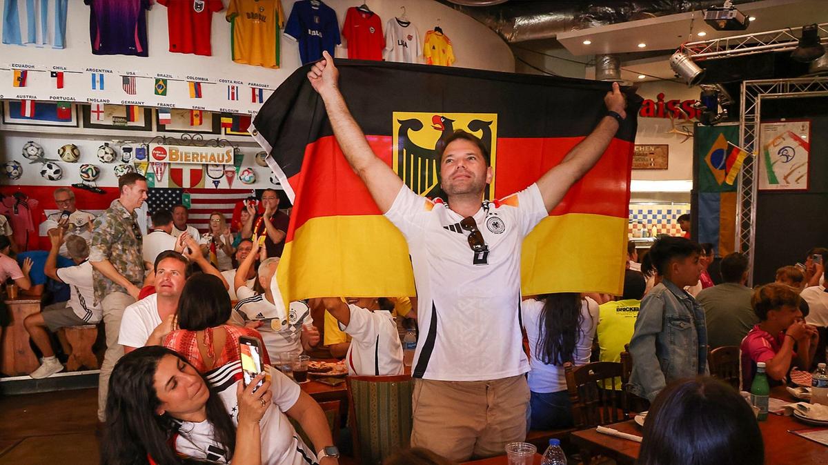 Julio Mendez Cohn of Doral proudly displays a German flag during the televised match between Germany and Switzerland at Fritz & Franz Bierhaus in Coral Gables, which is continuing its tradition of showing soccer matches after signing a new five-year lease with the City of Coral Gables.