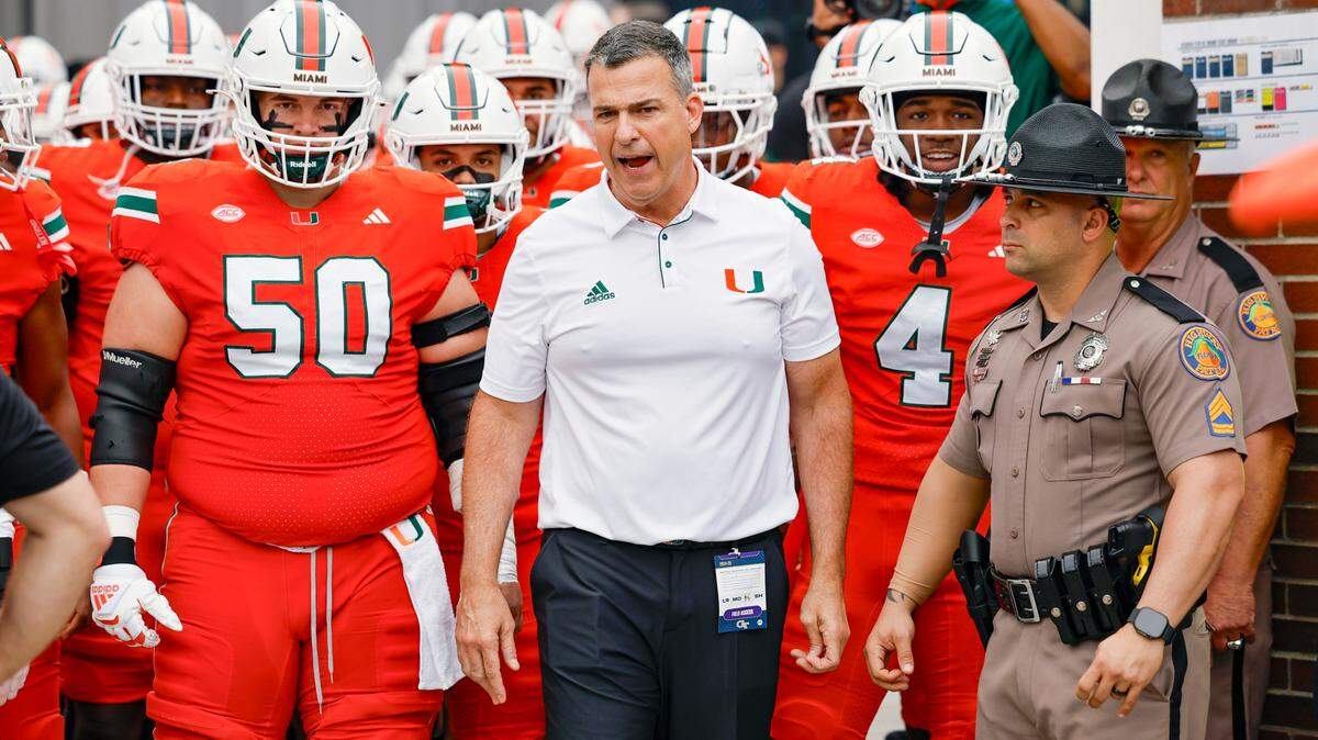 Miami Hurricanes head coach Mario Cristobal heads out to the field for the start of the game against the Georgia Tech Yellow Jackets during an NCAA game at Bobby Dodd Stadium at Hyundai Field in Atlanta, Georgia on Saturday, November 9, 2024.