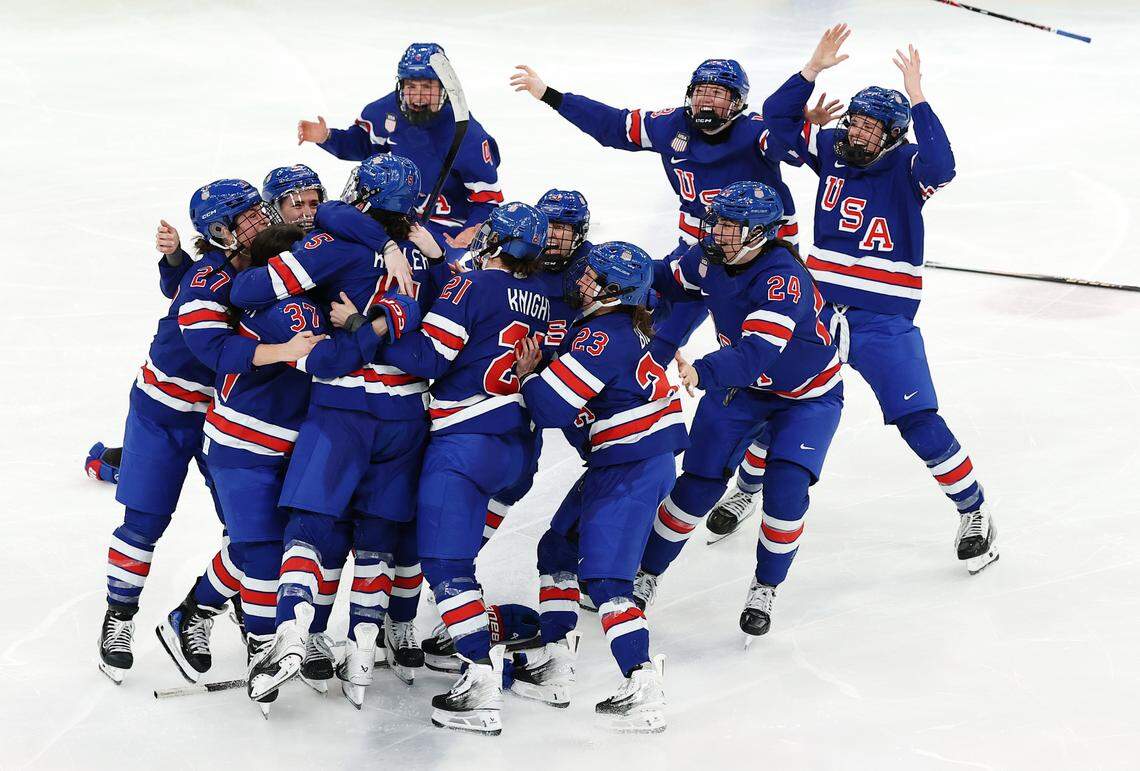 MILAN, ITALY - FEBRUARY 19: Players of Team United States celebrate winning the gold medal in overtime with a goal by Megan Keller #5 during the Women's Gold Medal match against Canada on day 13 of the Milano Cortina 2026 Winter Olympic games at Milano Santagiulia Ice Hockey Arena on February 19, 2026 in Milan, Italy. (Photo by Sarah Stier/Getty Images)