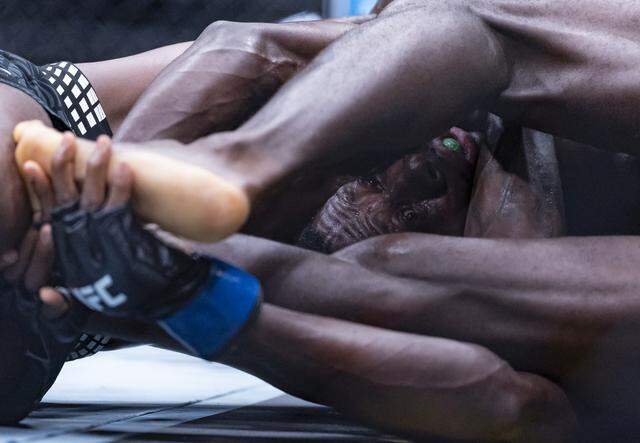 Kevin Holland of the United States and Randy Brown of Jamaica fight in their welterweight bout at UFC 327 at the Kaseya Center on Saturday, April 11, 2026, in downtown Miami, Fla.