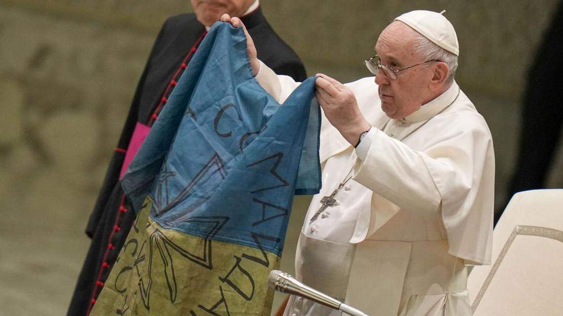 On April 6, Pope Francis displays a flag brought to him from Bucha, Ukraine, during his weekly general audience at the Vatican.