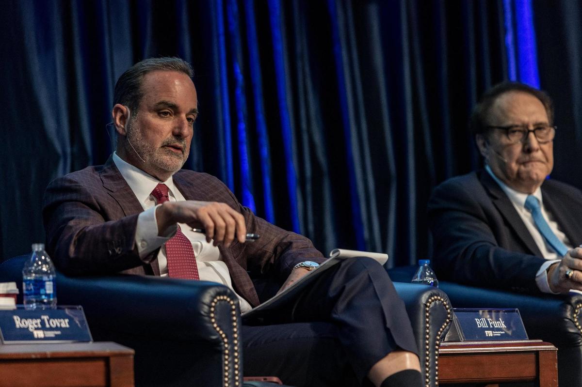 FIU Board of Trustee Roger Tovar, left, speaks during a community listening session on the FIU presidential search held at the Graham University Center, FIU Modesto A. Maidique Campus on April 13, 2022.