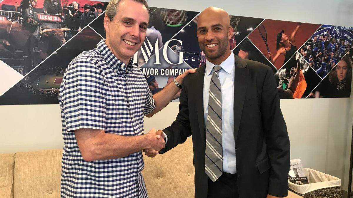 Miami Open Tournament Director James Blake and Fernando Chacon, executive director at Itaú Unibanco, shake hands following the contract signing at the US Open.