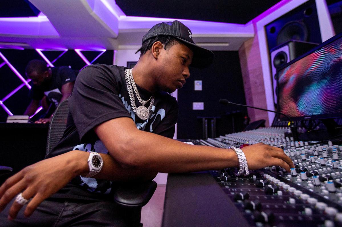 Producer ATL Jacob manipulates a mixing board at a recording studio in Miami, Florida, on Wednesday, September 7, 2022.