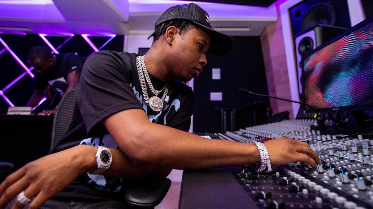 Producer ATL Jacob manipulates a mixing board at a recording studio in Miami, Florida, on Wednesday, September 7, 2022.