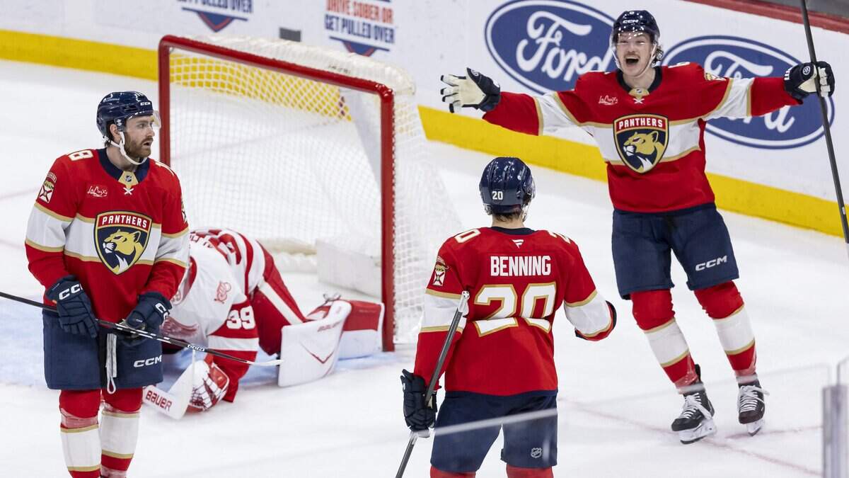 Florida Panthers defenseman Mike Benning (20) celebrates with defenseman Donovan Sebrango (6) after scoring against Detroit Red Wings goaltender Cam Talbot (39) in the second period of their NHL game at the Amerant Bank Arena on Wednesday, April 15, 2026, in Sunrise, Fla.