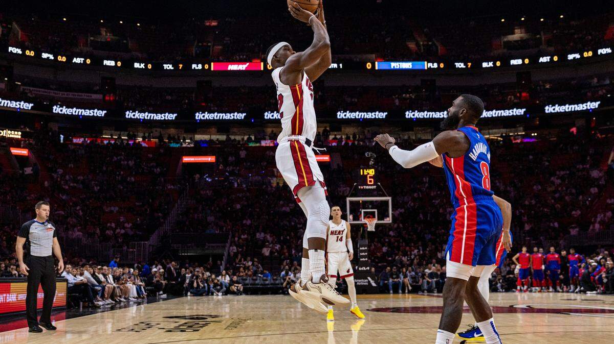 Former Miami Heat forward Jimmy Butler (22) takes a jump shot over Detroit Pistons forward Tim Hardaway Jr. (8). Jumping in basketball can lead to injuries to the tendon that attaches to your kneecap.