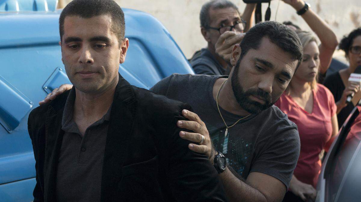 Brazilian “celebrity” surgeon Dr. Denis Cesar Barros Furtado is escorted by police after his arrest in Rio de Janeiro, Brazil, Thursday, July 19, 2018. The 45-year-old buttocks enlargement specialist, also known as Dr. “Bumbum” or Dr. Fanny, fled when one of his female patients died after a surgical procedure conducted in his apartment. (AP Photo/Leo Correa)