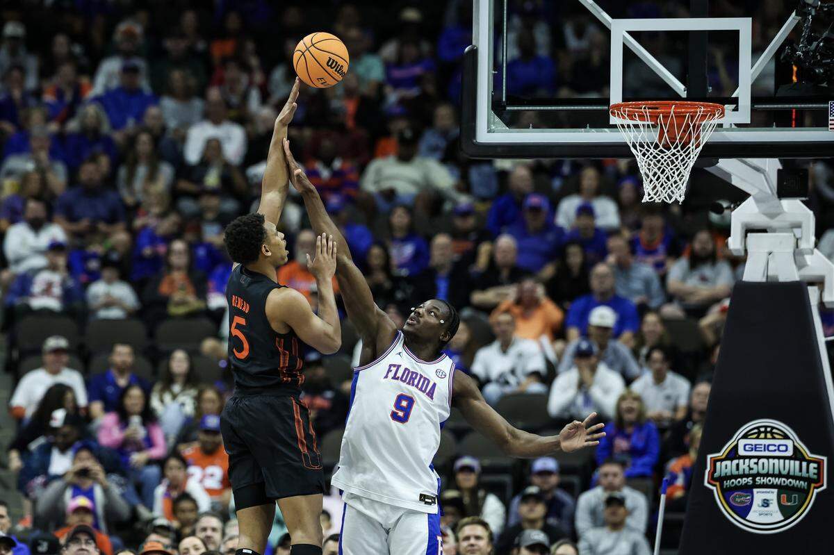 JACKSONVILLE, FLORIDA - NOVEMBER 16: Malik Reneau #5 of the Miami Hurricanes shoots the ball against Rueben Chinyelu #9 of the Florida Gators during the first half of a game in the Jacksonville Hoops Showdown at VyStar Veterans Memorial Arena on November 16, 2025 in Jacksonville, Florida. (Photo by James Gilbert/Getty Images)