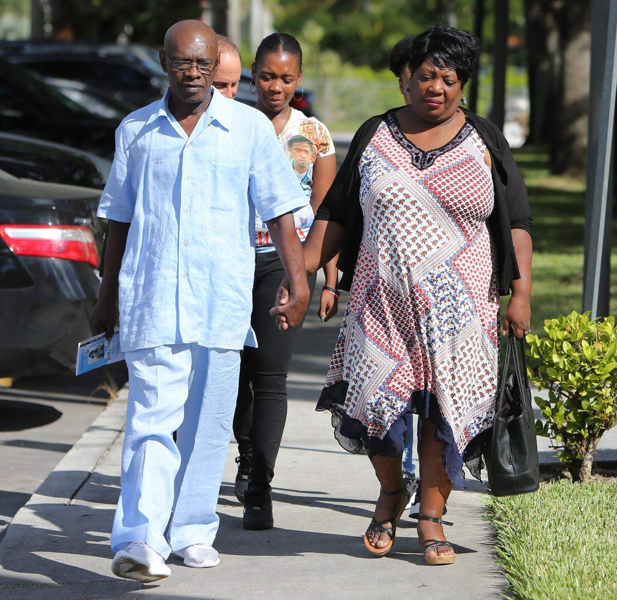 Levi and Youseline Pierre Simon, the parents of 23-year-old shooting victim, Juvon Simon, arrive outside of City Hall in Florida City along with their daughter, Lucy Simon  on Oct. 31, 2018. The family was there to announced that they are filing suit against Florida City and the state for son’s death. Juvon was killed on May 30, 2018 by Florida City detective Frantz Hardy.