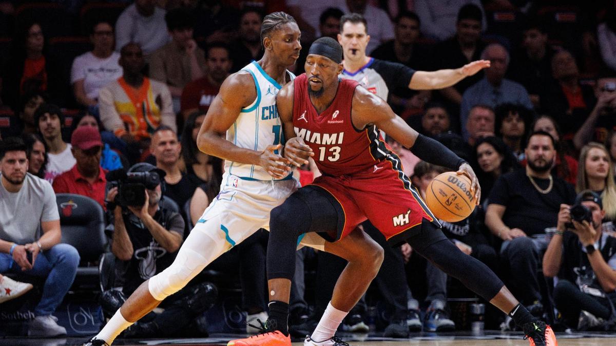 Miami Heat center Bam Adebayo (13) dribbles against Charlotte Hornets forward Moussa Diabate (14) during the first half of a game on March 10, 2025, at Kaseya Center in Miami.