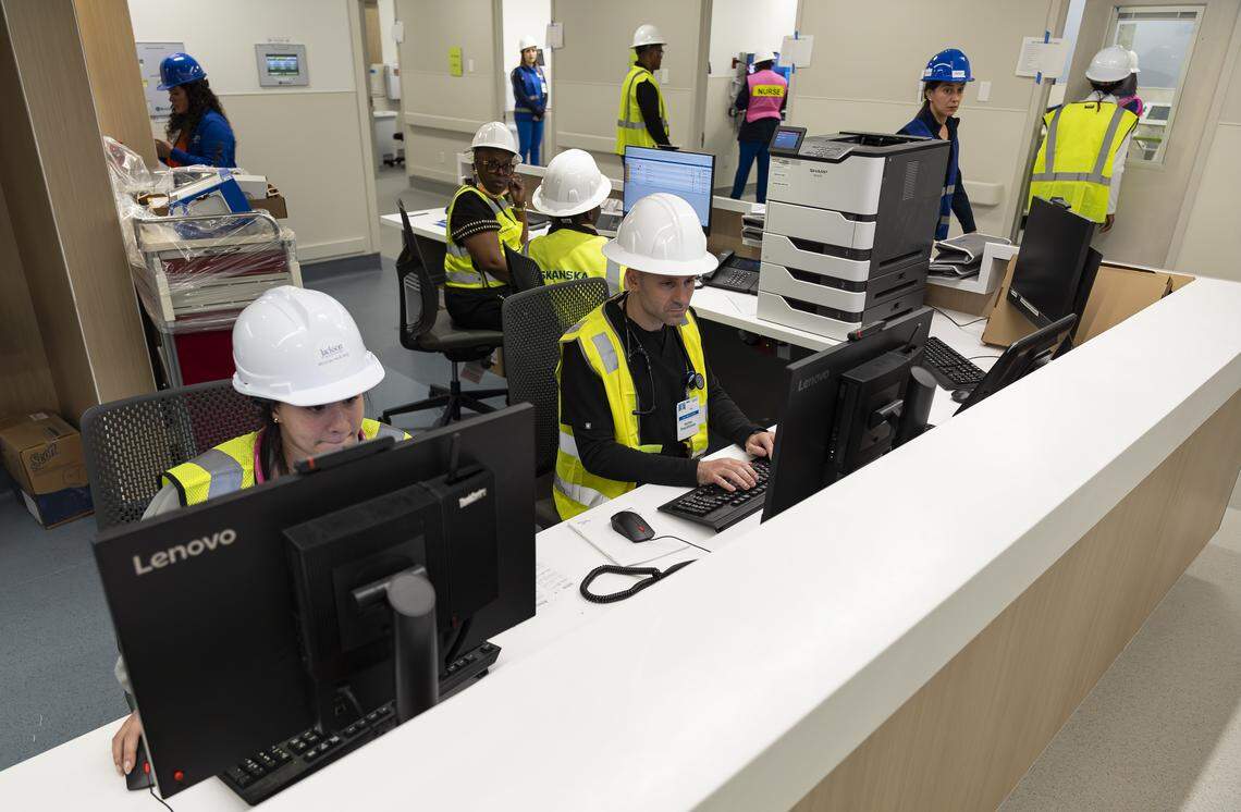 Jackson Memorial Hospital nurse practitioner Eli Bryski, center, uses a computer at a nurses' station during a tour of the hospital's new emergency department on Thursday, March 5, 2026, in Miami, Fla. The new facility doubles the size of the current emergency room and is expected to reduce patient wait times.