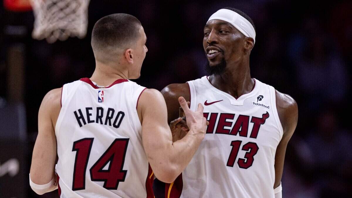 Miami Heat guard Tyler Herro (14) reacts with center Bam Adebayo (13) during the second half of an NBA game against the New Orleans Pelicans at the Kaseya Center on Wednesday, January 1, 2025, in Miami, Fla.