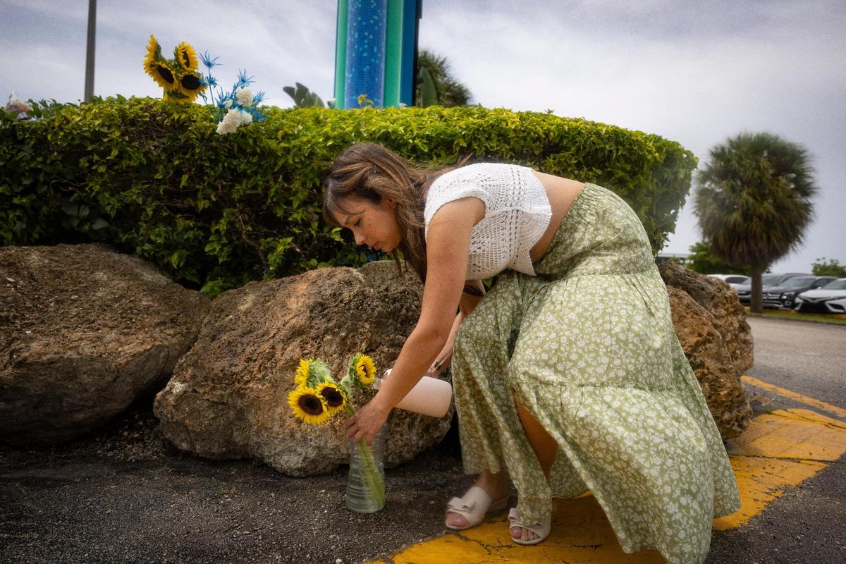 Maria Fernandez drops off flowers for Lolita during a gathering two days after Lolita’s death outside the Miami Seaquarium on Sunday, Aug. 20, 2023, on Rickenbacker Causeway before Key Biscayne. “I grew up in Key Biscayne and I was always pro them letting her go, and now it’s too late,” said Fernandez.