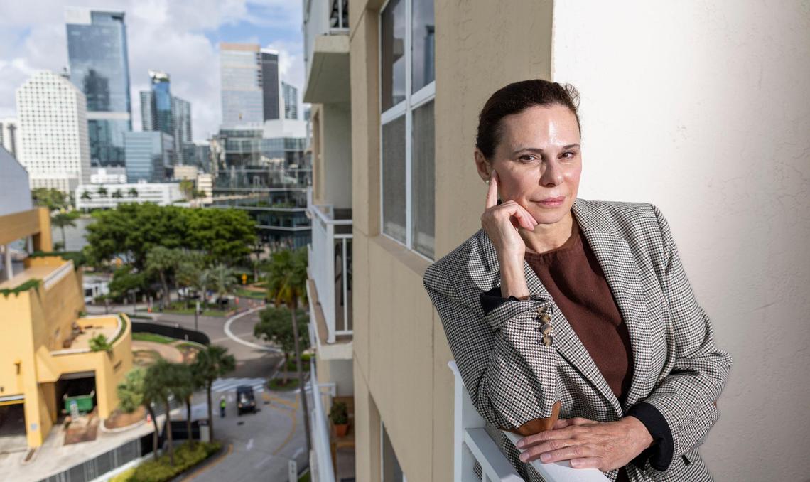 Cynthia Muniz is photographed on the balcony of her Brickell Key condo on Friday, July 18, 2025, in Miami. Once she sells her condo, Muniz says she’s considering leaving Florida due to the state’s rising cost of living. 