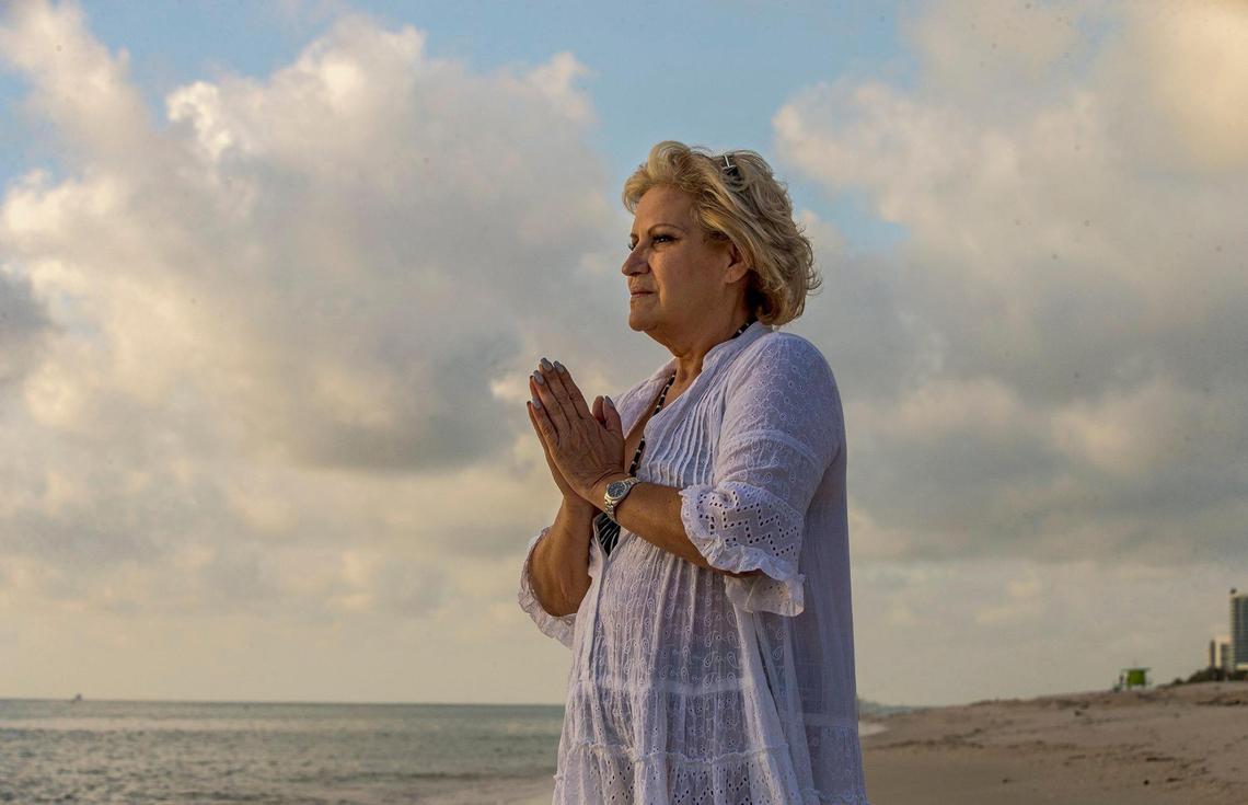 Iliana Monteagudo reacts as she walks along the beach behind the apartment she is renting now in Miami Beach. She is one of the few survivors from the collapsed portion of Champlain Towers South. She escaped from unit 611 by running down six flights of stairs, on Thursday, Sept. 9, 2021.