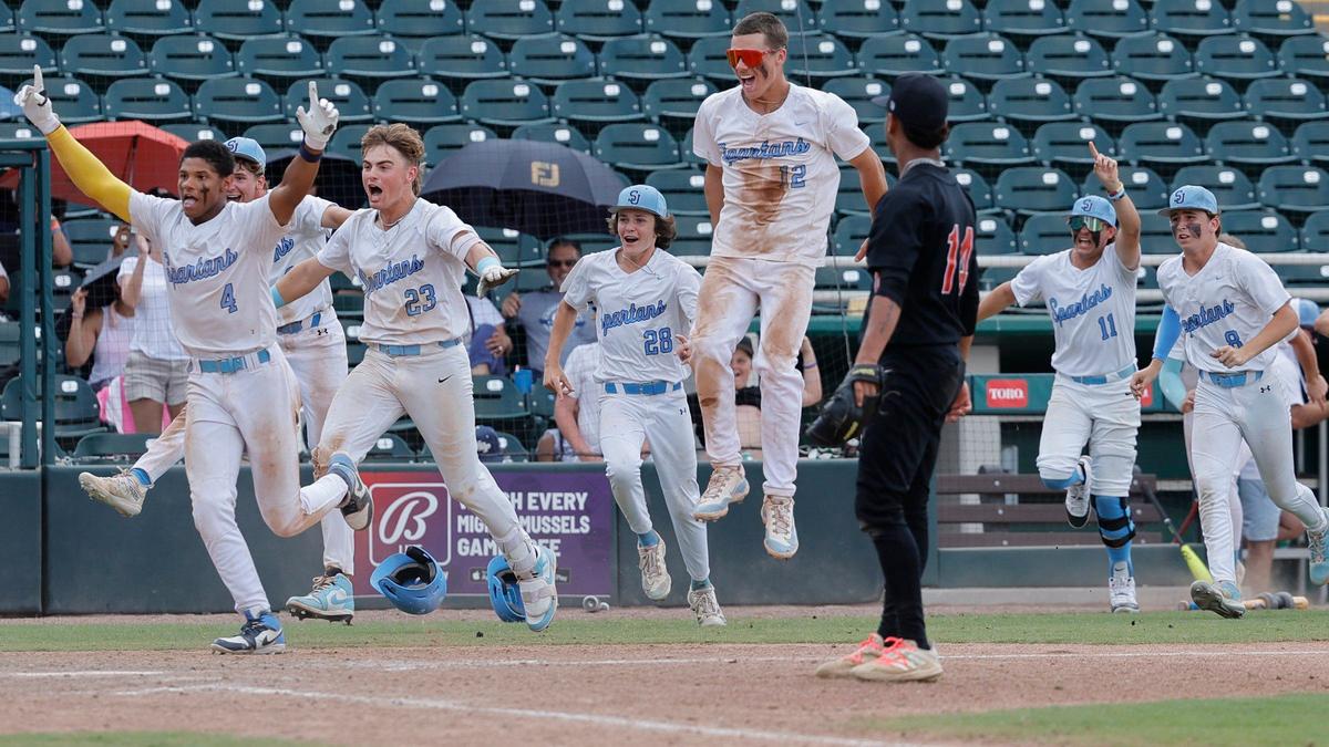 Miami Christian Victors Hector Escobar (14) watches the St. Johns Spartans celebrate after the Spartans defeat the Victors in extra innings during the FHSAA Baseball Class 2A State Final at Hammond Stadium in Fort Myers, Florida on Wednesday, May 22, 2024.