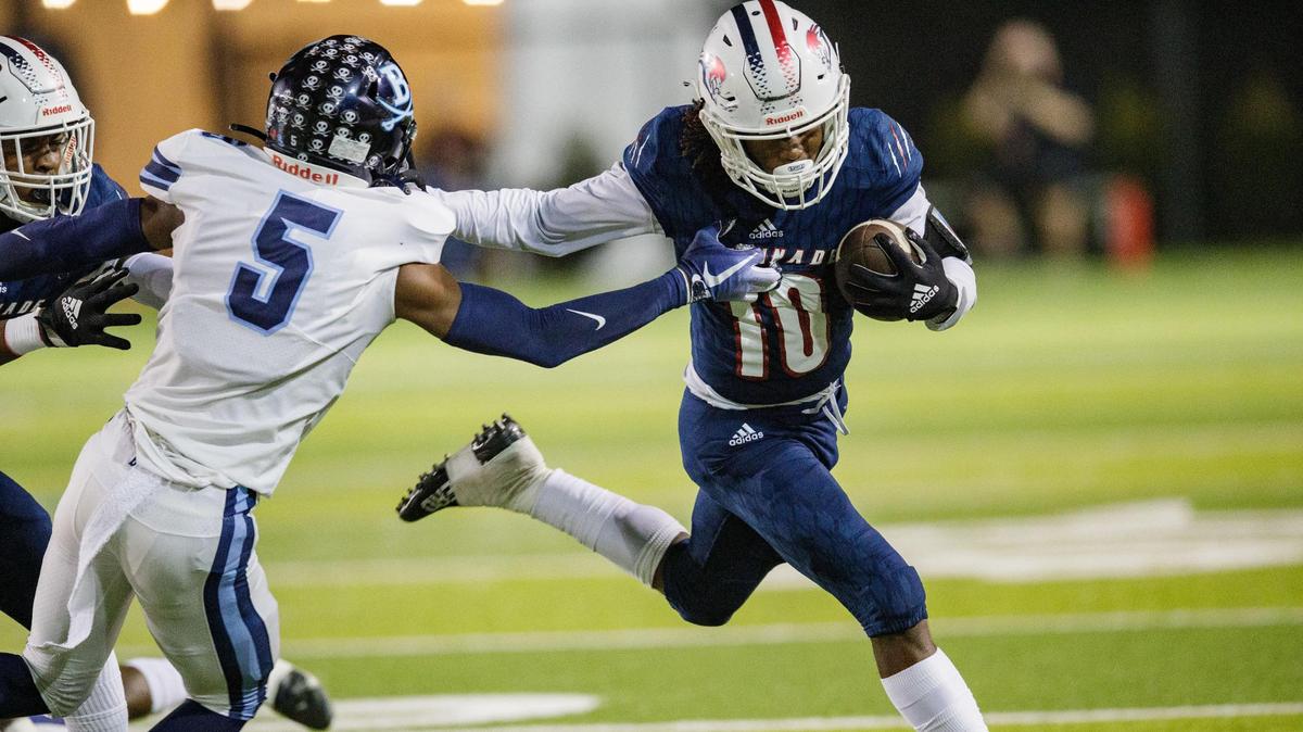 Chaminade-Madonna’s Duane Thomas Jr. (10) pushes off a defender as he makes his way down the field. Chaminade-Madonna leads Berkeley Prep 7-0 at the half of the 3A State Championship game at Gene Cox Stadium on Friday, Dec. 10, 2021.