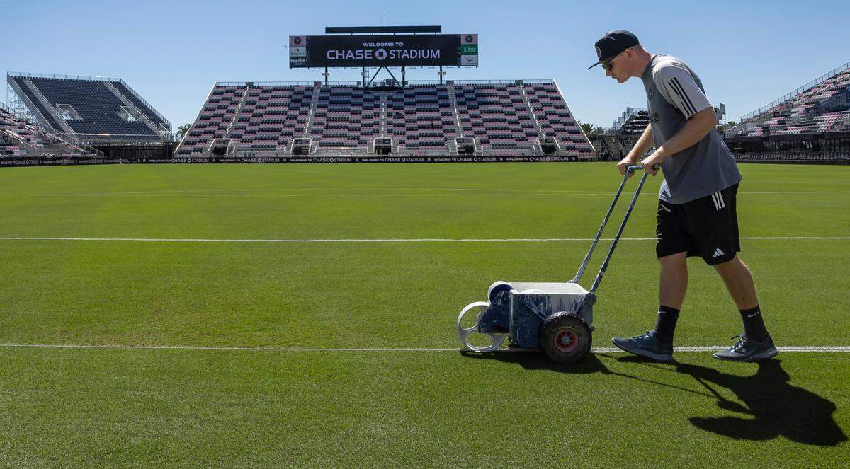 A staff member paints the field before the start of Inter Miami’s MLS season opener against Real Salt Lake at Chase Stadium on Tuesday, Feb. 20, 2024, in Fort Lauderdale, Fla.