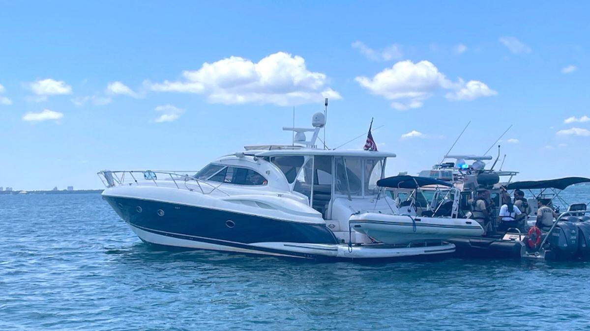 Local police and federal agents stop a 60-foot yacht near Key Biscayne Friday, April 19, 2024. Authorities say the 31 people from Haiti were being smuggled on the vessel.
