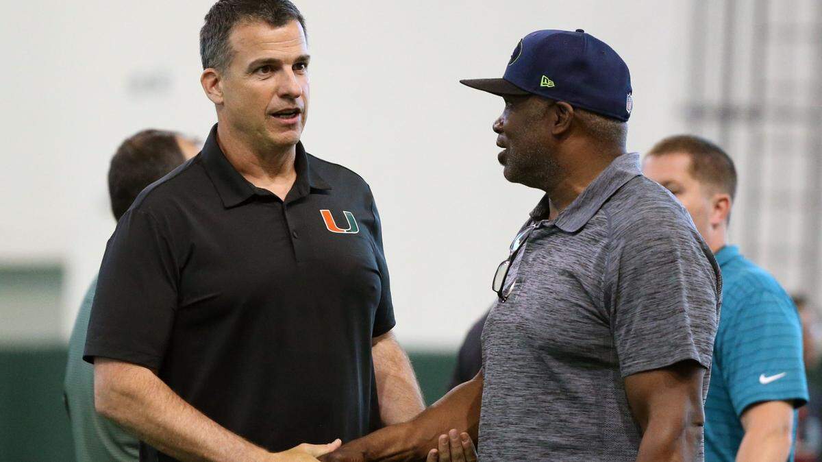 Miami Hurricanes football coach Mario Cristobal talks with former Cane player Alonzo Highsmith as graduating seniors perform for scouts at Pro Day at the University of Miamis Carol Soffer Indoor Practice Facility in Coral Gables on Wednesday, March 30, 2022 ahead of the 2022 NFL Draft.