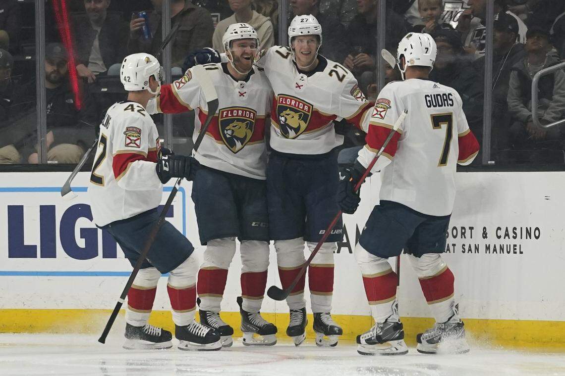 The Florida Panthers celebrate after center Eetu Luostarinen (27) scored during the second period of an NHL hockey game against the Los Angeles Kings Sunday, March 13, 2022, in Los Angeles. (AP Photo/Ashley Landis)