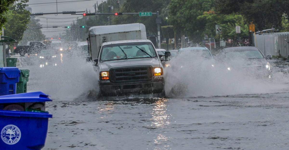 Commuters drive through flooded Southwest 67th Avenue in Miami on Sept. 9, 2025. More storms and flooding is expected into the weekend.