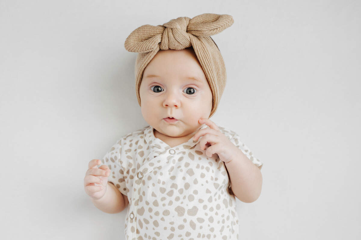 baby girl wearing brown hat