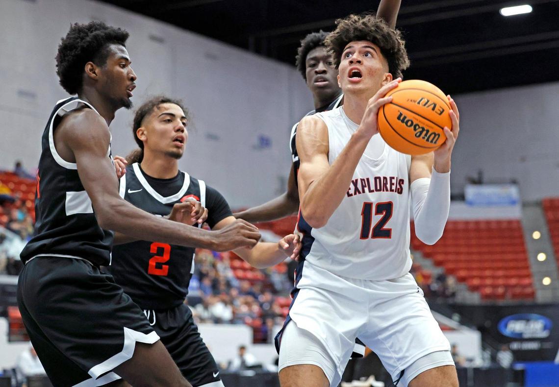 Columbus Explorers Cameron Boozer (12) looks to shoot as Colonial High School players defend in the third quarter during the FHSAA semifinal at the RP Funding Center in Lakeland, Florida on Friday, March 3, 2023.