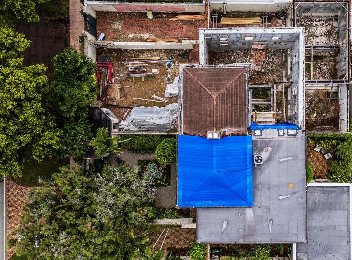 An overhead view of a landmark 1925 home in Coral Gables’ historic French City Village that is in danger of collapsing after years of neglect by its owners, top, shows missing roofs and a gutted interior. The house’s hazardous condition has caused extensive damage to the roof and walls of the attached home at bottom, which is still occupied.
