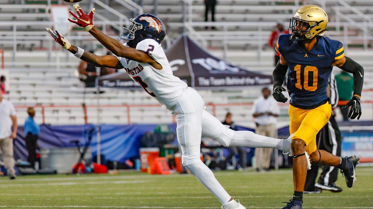 Homestead Broncos Cortez Mills (2) dives for a first down pass reception as St. Thomas Aquinas Bryant Allen (10) defends in the second half of the Class 3M state championships at Bragg Memorial Stadium in Tallahassee, Florida on Saturday, December 9, 2023.