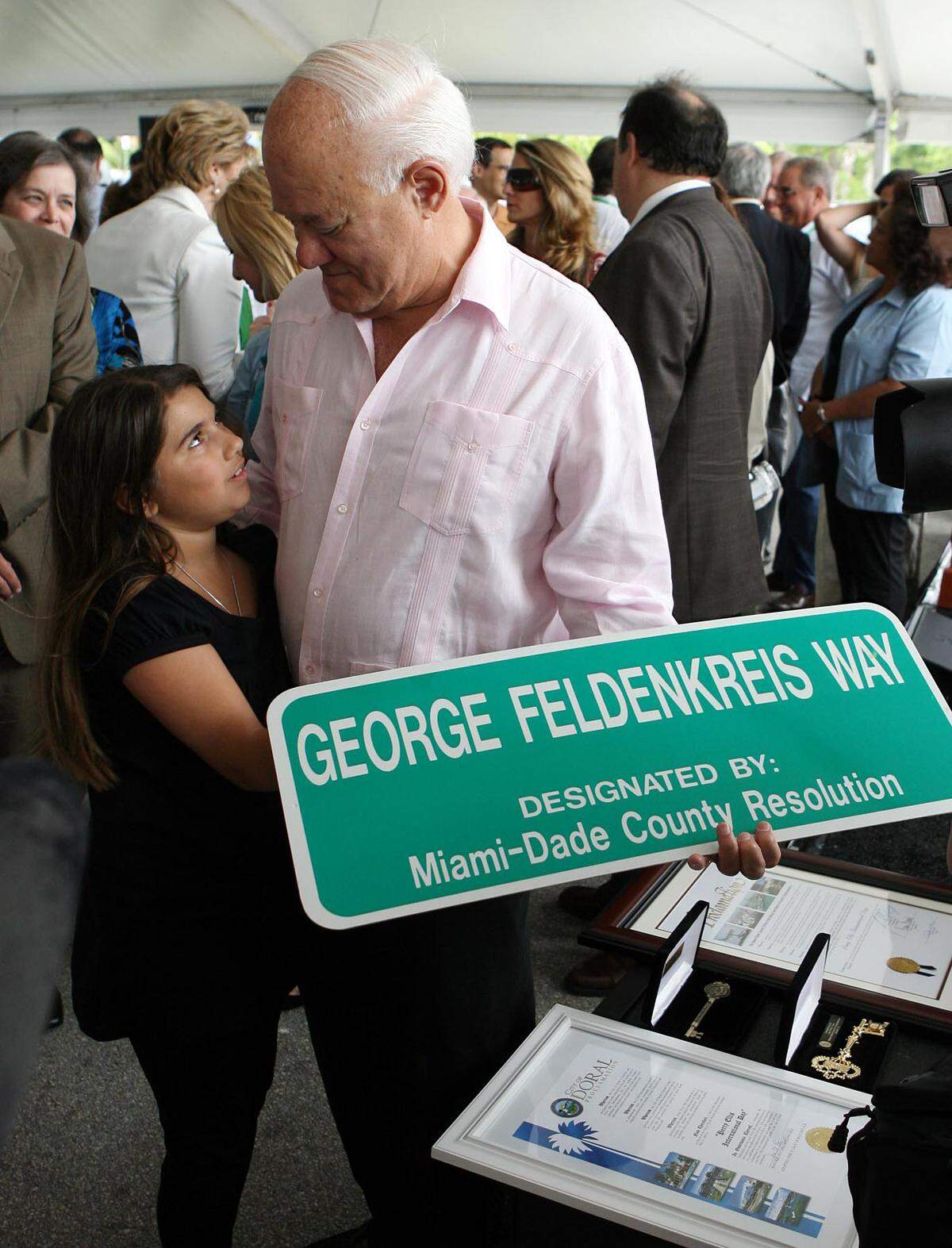 In rthis file photo from May 31, 2007, Perry Ellis International CEO George Feldenkreis is pictured with his then 8-year-old granddaughter Daniella Hanono during the presentation of the George Feldenkreis Way at Doral along 107th Avenue from 25th to 41st streets.