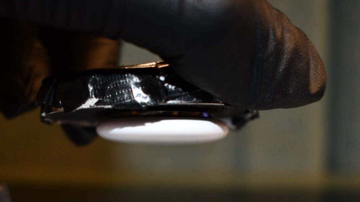 A Key West police officer holds an Apple AirTag that detectices say was placed underneath a car in an effort to track the vehicle on Nov. 8, 2024.