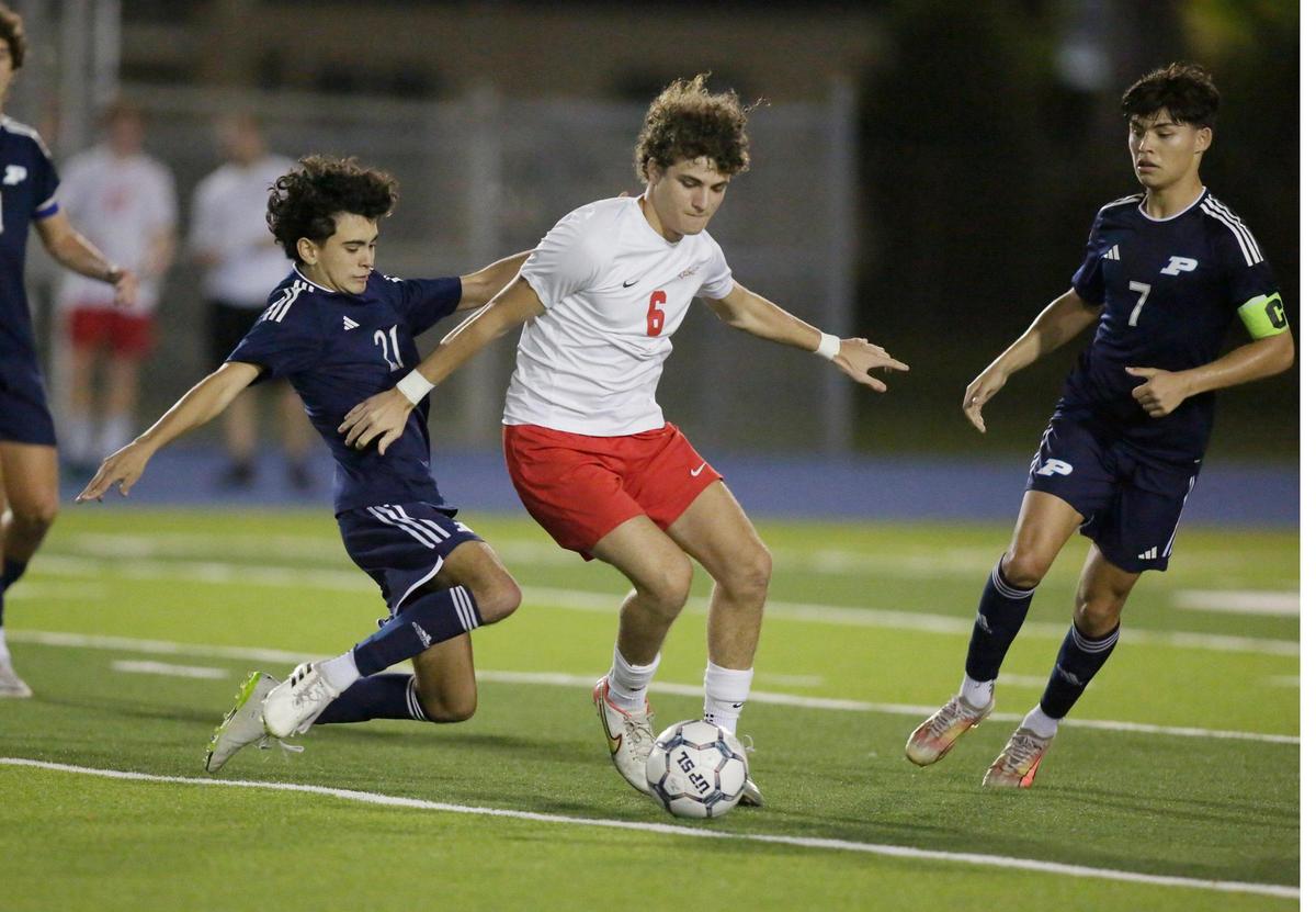 Palmetto players challange for the ball MAST Academy Cristobal Tedin during GMAC Boys Soccer Championship game on Friday, January 12, 2024 at Traz Powell Stadium in Miami.